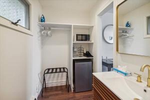 a bathroom with a sink and a mirror at 5 min Drive to DT Petoskey Lake Views Workspace in Petoskey