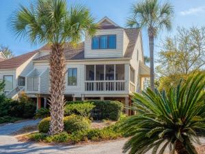 a house with palm trees in front of it at 724 Spinnaker Beach Villa in Seabrook Island