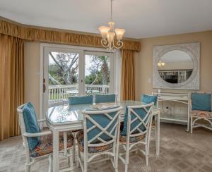 a dining room with a table and chairs and a window at 724 Spinnaker Beach Villa in Seabrook Island