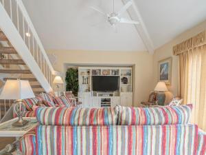 a living room with a couch and a television at 724 Spinnaker Beach Villa in Seabrook Island