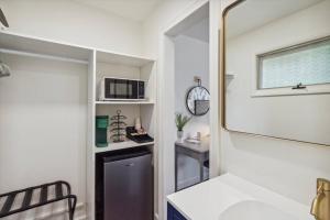 a small bathroom with a sink and a microwave at Million Dollar Views of Petoskey Bay DTPetoskey in Petoskey