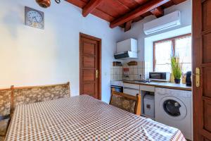 a kitchen with a table and a washing machine at Aranyrózsa Porta in Balatonszárszó