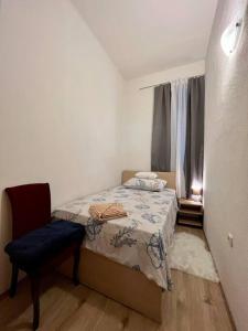 ein kleines Schlafzimmer mit einem Bett und einem Stuhl in der Unterkunft Studio Apartman Ana in Lastovo