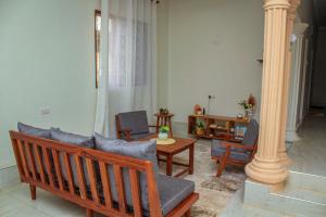 a living room with a couch and chairs and a table at Kwale Residence in Kiembi Samaki