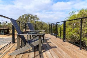 a patio with two chairs and a table on a deck at New The Sunrise Cozy Container Home in Fredericksburg