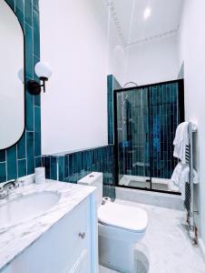 a bathroom with a toilet and a sink and a mirror at Bayswell Park Hotel in Dunbar