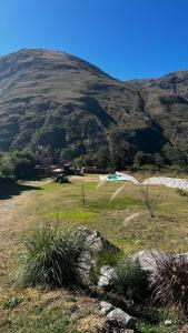 a field of grass with a mountain in the background at Santuyoc Lodge in Volcán