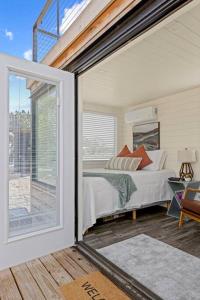a bedroom with a bed and a large window at New The Sunset Luxury Container Home in Fredericksburg