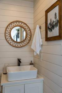 a bathroom with a white sink and a mirror at New The Sunset Luxury Container Home in Fredericksburg
