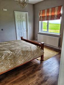 a bedroom with a bed and a window at Lighthouse Farm in Greencastle