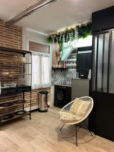 a living room with a chair and a refrigerator at LA FACTORY in Perpignan