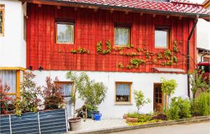 a red and white house with plants on it at Stunning Apartment In Deggingen With Wifi in Deggingen
