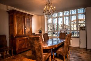 a dining room with a wooden table and chairs at Demeure D'Argonne in Sainte-Menehould
