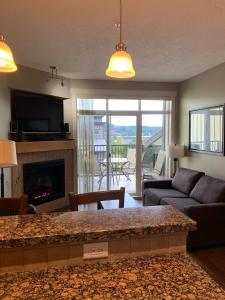 a living room with a couch and a fireplace at Race Rocks Townhouse - Sooke in Sooke