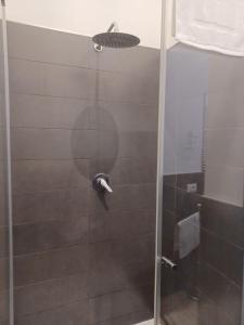 una doccia con una porta in vetro in un bagno di GIORGISA a Palermo Altre 33 foto