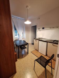 a kitchen with a table and a dining room at Nest Rest in La Spezia
