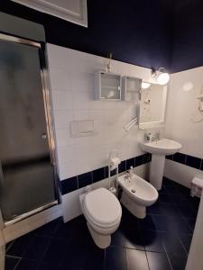 a bathroom with a toilet and a sink and a shower at Nest Rest in La Spezia