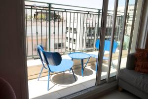 two chairs and a table on a balcony at Two Bedrooms - Spacy Family Apartment - Ben yehuda - Host By Bookiz in Tel Aviv