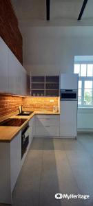 a kitchen with a white refrigerator and a sink at Entrez Apartments 4 - City centre in Košice