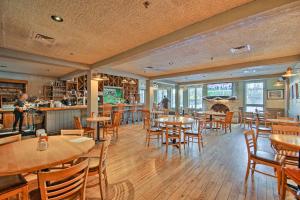 a restaurant with tables and chairs and a fireplace at Updated Retreat with Golf Course and Wildlife Views! in Galena