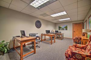 an office with three desks and chairs and a clock on the wall at Updated Retreat with Golf Course and Wildlife Views! in Galena +37 photos