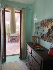 a room with a dresser and a door to a patio at DOMUS PARVA - Villa con bio-piscina, spa privata e appartamenti panoramici in Bacoli