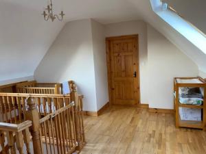 a room with a staircase and a wooden door at Beechwood View in Kilrush