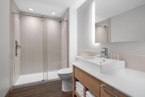 a bathroom with a toilet and a sink and a shower at Element by Marriott Tampa Midtown in Tampa