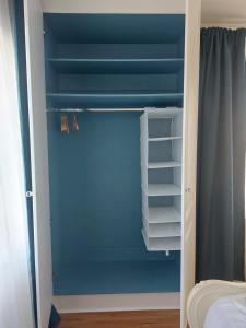 a closet with blue walls and a blue ceiling at Grá na Farraige in Enniscrone
