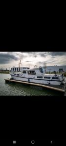 two boats are docked at a dock in the water at Une nuit sur l'eau à bord de l'IDEAAL in Nevers