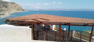 a roof on top of a building next to the water at Loggia Two in Agia Galini
