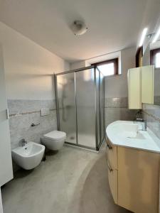 a bathroom with a shower and a toilet and a sink at Casa Margheritina in Malcesine