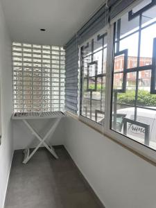 an empty room with a large window in a building at Don Bosko Cozy Heaven Apartments 2 in Tirana