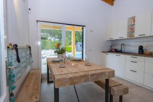 a kitchen with a wooden table in a room at Alcudia Beach House in Alcudia