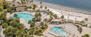 an overhead view of a resort with two pools and a beach at 542 Tarpon Pond Cottage in Seabrook Island