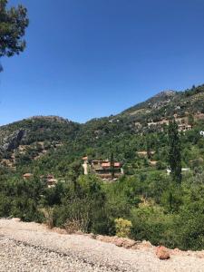 a view of a mountain with a town in the distance at Villa Alaçatı (İslamlar-Kalkan) in Kaş