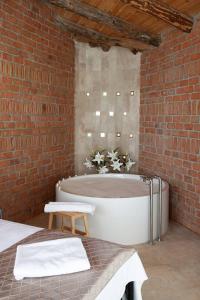 a bathroom with a bath tub in a brick wall at Villa Alaçatı (İslamlar-Kalkan) in Kaş