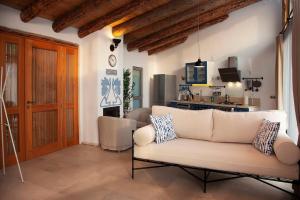 a living room with a white couch and a kitchen at Villa Alaçatı (İslamlar-Kalkan) in Kaş