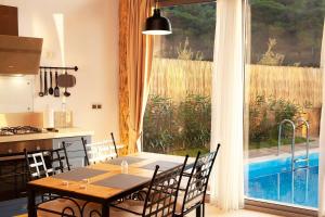 a dining room with a table and a large window at Villa Alaçatı (İslamlar-Kalkan) in Kaş +11 photos
