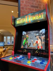 a game on a virtual jumanji game machine at 4-bed Cotswold getaway with hot tub & gaming room in Churchdown