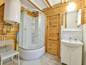 a bathroom with a tub and a shower and a sink at Holiday homes, Kolobrzeg in Kołobrzeg