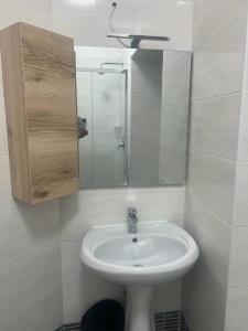 a white bathroom with a sink and a mirror at Roma Palace in Rome