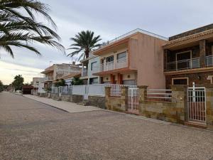 una fila de casas en una calle con palmeras en Beachhouse, Beautiful space, beautiful sea view, on the beach, en Cartagena