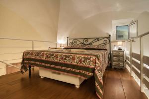 a bedroom with a large bed and a night stand at Appartamento dal Millenovecentotto in Gaeta