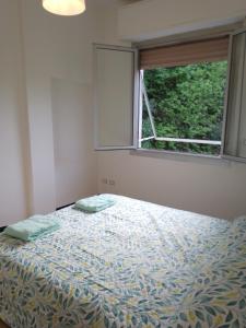 Schlafzimmer mit einem Bett und einem Fenster in der Unterkunft Appartamento vicino iclas in Rapallo
