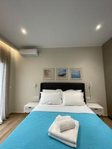 een slaapkamer met een groot bed en handdoeken bij Seaside Archontiko in Arkondikó
