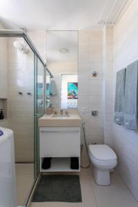 a bathroom with a toilet and a sink and a shower at Studio Catete in Rio de Janeiro
