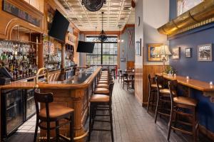 a bar with wooden bar stools in a restaurant at Landmark Inn in Marquette