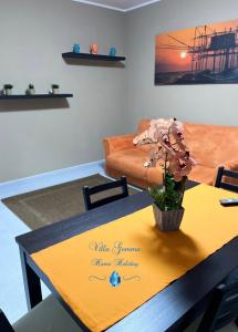 a living room with a table and a couch at Villa Gemma in Campomarino