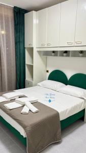 a large bed with white cabinets and towels on it at Villa Gemma in Campomarino